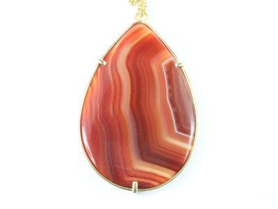 un gros plan d'un pendentif orné d'une pierre rouge