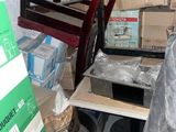 a pile of boxes and a chair in a room
