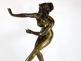 bronze statue of a woman holding a tennis racquet on a marble base