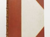a brown and white book sitting on top of a white table