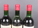 three bottles of wine are lined up on a table