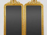 a pair of antique gold framed mirrors