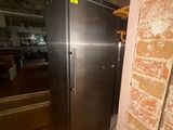 an image of a stainless steel refrigerator in the corner of a room