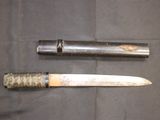 two knives that are laying next to each other on a table