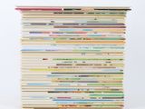 a stack of books stacked on top of each other on a table