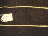 a gold chain with a price tag on it