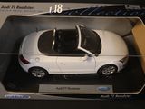 a white toy car in a box on a table