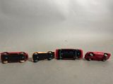 four toy cars that are lined up in a row
