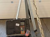 a tripod and a tool case in a garage