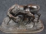 bronze statue of a horse and a rider on a rock