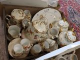 a box full of tea and coffee cups and saucers