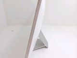 a computer monitor sitting on a stand in a white room