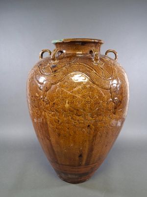 a brown vase that is sitting on a table