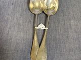 two spoons that are sitting on a table