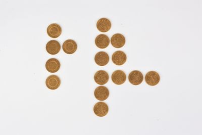 an image of a number of gold coins arranged in the shape of a man