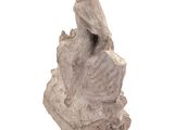 a statue of a woman sitting on a rock with a bird on her shoulder