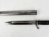 two different types of knives on a white surface