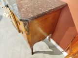 a wooden cabinet with a marble top in a room