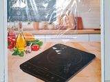 an image of a box containing a cooktop with a picture of a woman in the background