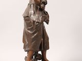 a bronze statue of a woman holding a child on a pedestal