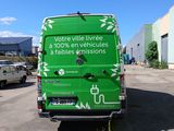 a green van that is parked in a parking lot