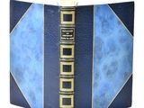 a blue book with gold trim and a blue cover