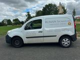 a white van that is parked on the side of the road