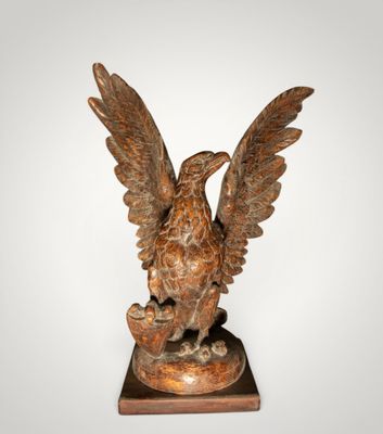 an image of a statue of a bird on a wooden base