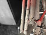 a close up of a bicycle with a red handlebar