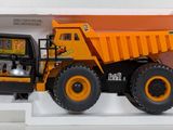 a toy dump truck in a white box on a table