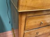 a tv on top of a wooden dresser in a room