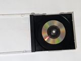 a cd in a clear case on a white surface