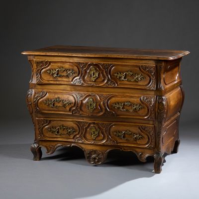 an antique chest of drawers with ornate carvings on top of it