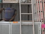 a man that is standing on a ladder in a building
