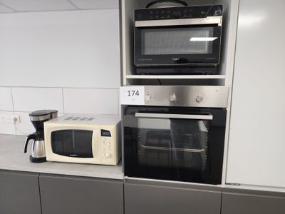 two microwaves and a toaster oven in this kitchen
