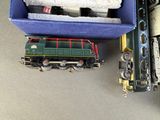 a toy train sitting next to a box of other toy trains