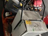a pile of old appliances on a pallet in a parking lot