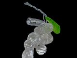 a glass figurine with a green leaf on top of it