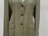 a mannequin wearing a green and black jacket on a mannequin stand
