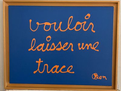a blue sign with orange writing on it on a wall