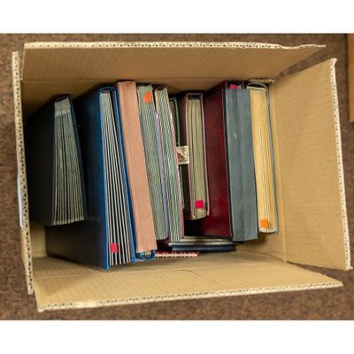 a cardboard box filled with books on top of a table