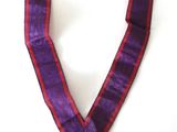 an image of a purple ribbon with a gold medal on it