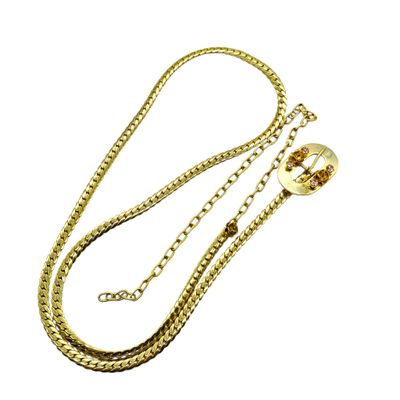 a close up of a gold chain with a ball on it