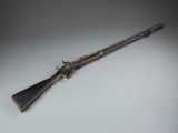 an old gun on a white surface with a black background