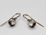 a pair of black and white glass earrings on a white background