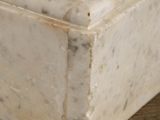 a marble box with a pair of shoes on top of it
