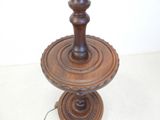 a wooden table with a lamp on top of it