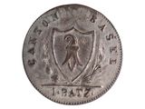 une vieille pièce d'argent sur laquelle figure un blason