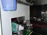 pots and pans hanging from the ceiling in a kitchen