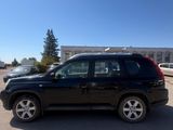 the black suv is parked in the parking lot outside of the building